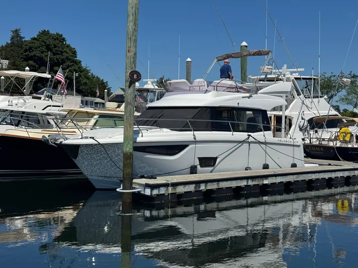 Portkey Yacht Photos Pics 2016 Jeanneau Velasco 37F yacht docked at marina, surrounded by other boats.