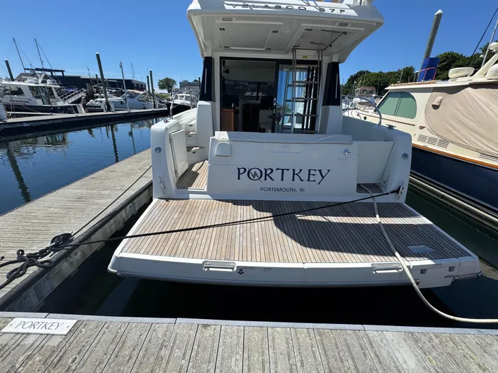 Portkey Yacht Photos Pics 2016 Jeanneau Velasco 37F docked at a marina, rear view.