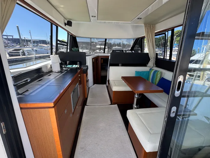 Portkey Yacht Photos Pics Interior of 2016 Jeanneau Velasco 37F yacht with modern kitchen and seating area.