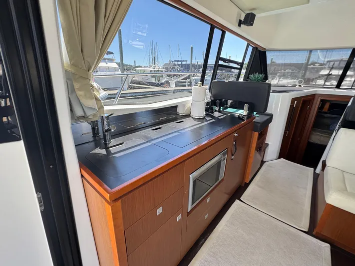 Portkey Yacht Photos Pics Interior of 2016 Jeanneau Velasco 37F yacht with modern kitchen and marina view.