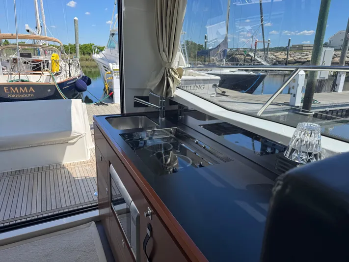 Portkey Yacht Photos Pics Interior view of 2016 Jeanneau Velasco 37F yacht kitchen with dockside boats.