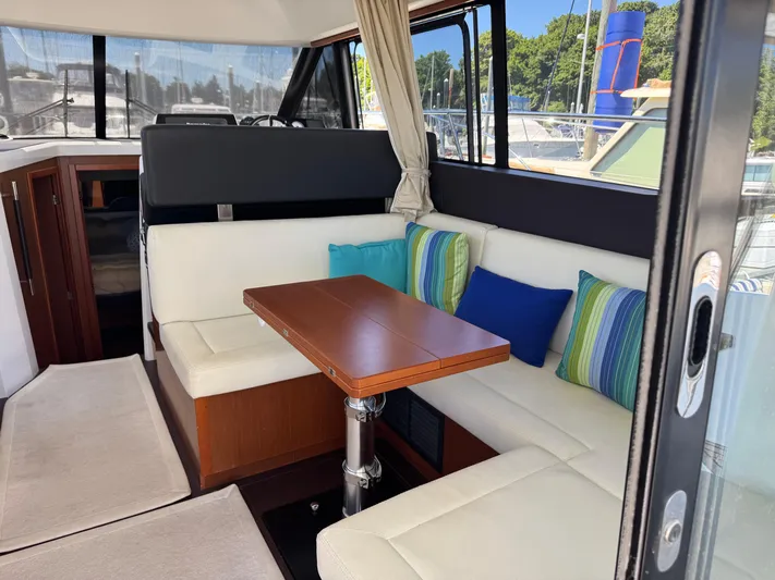 Portkey Yacht Photos Pics Interior of 2016 Jeanneau Velasco 37F with cozy seating and colorful cushions.