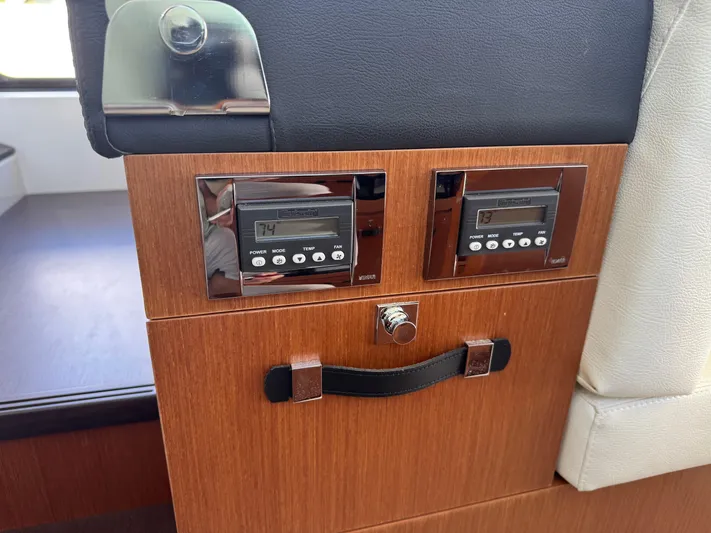 Portkey Yacht Photos Pics Control panel on a 2016 Jeanneau Velasco 37F yacht, featuring digital displays and wood finish.