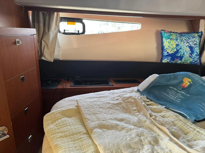 Portkey Yacht Photos Pics Cozy cabin interior of 2016 Jeanneau Velasco 37F with bed and window.