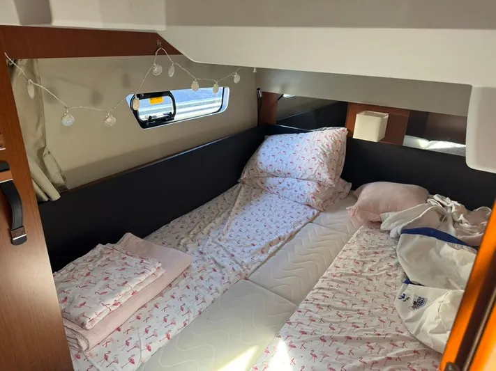 Portkey Yacht Photos Pics Cozy cabin interior of 2016 Jeanneau Velasco 37F with flamingo-themed bedding.