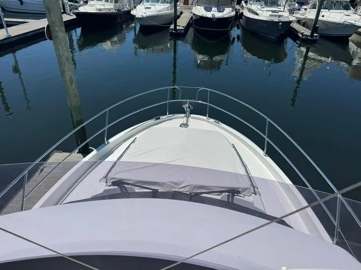 Portkey Yacht Photos Pics 2016 Jeanneau Velasco 37F yacht docked at marina, surrounded by water and other boats.