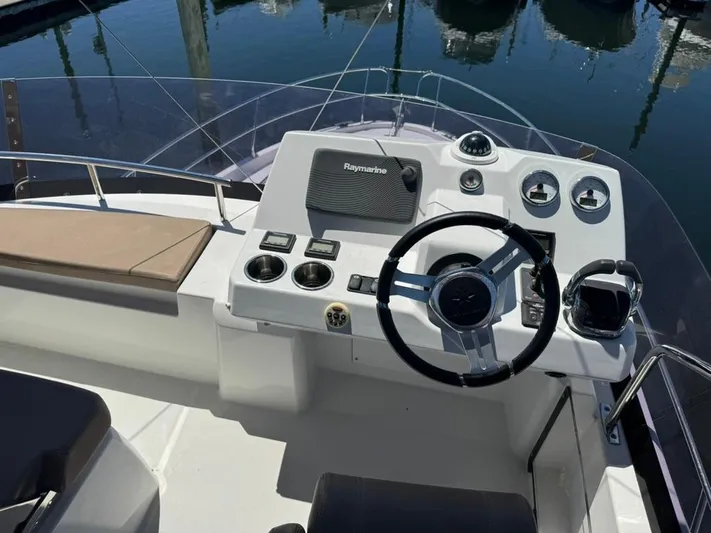 Portkey Yacht Photos Pics 2016 Jeanneau Velasco 37F boat helm with steering wheel and navigation controls.