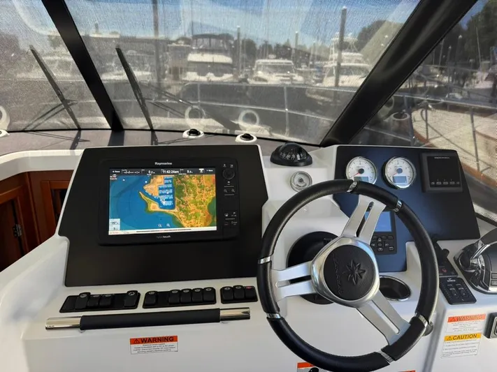 Portkey Yacht Photos Pics Helm of 2016 Jeanneau Velasco 37F with navigation display and steering wheel.