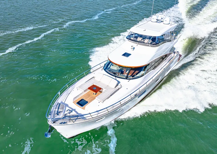 Dog House Yacht Photos Pics 2025 Belize 66 Daybridge yacht cruising on open water, aerial view.