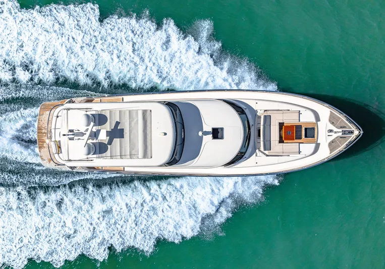 Dog House Yacht Photos Pics Aerial view of 2025 Belize 66 Daybridge yacht cruising on turquoise water.