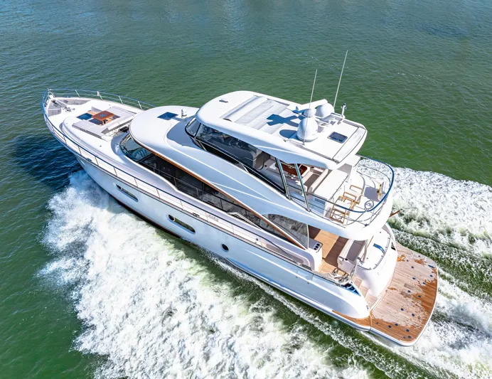 Dog House Yacht Photos Pics 2025 Belize 66 Daybridge yacht cruising on open water, showcasing sleek design and luxury features.