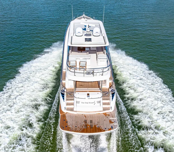 Dog House Yacht Photos Pics 2025 Belize 66 Daybridge yacht cruising on open water, rear view.