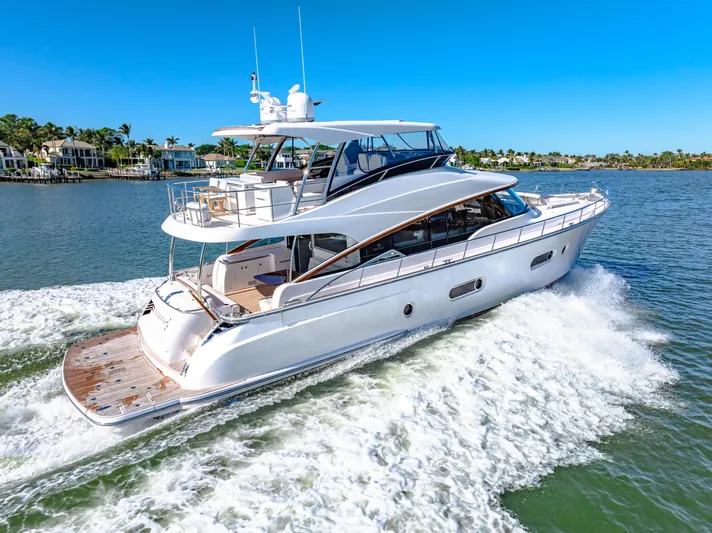 Dog House Yacht Photos Pics 2025 Belize 66 Daybridge yacht cruising on a sunny day, showcasing sleek design and luxury.