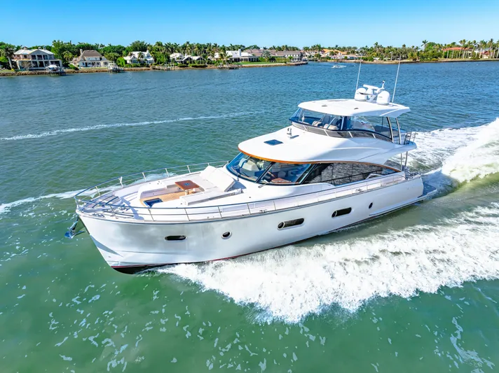 Dog House Yacht Photos Pics 2025 Belize 66 Daybridge yacht cruising on a sunny day in a scenic waterway.