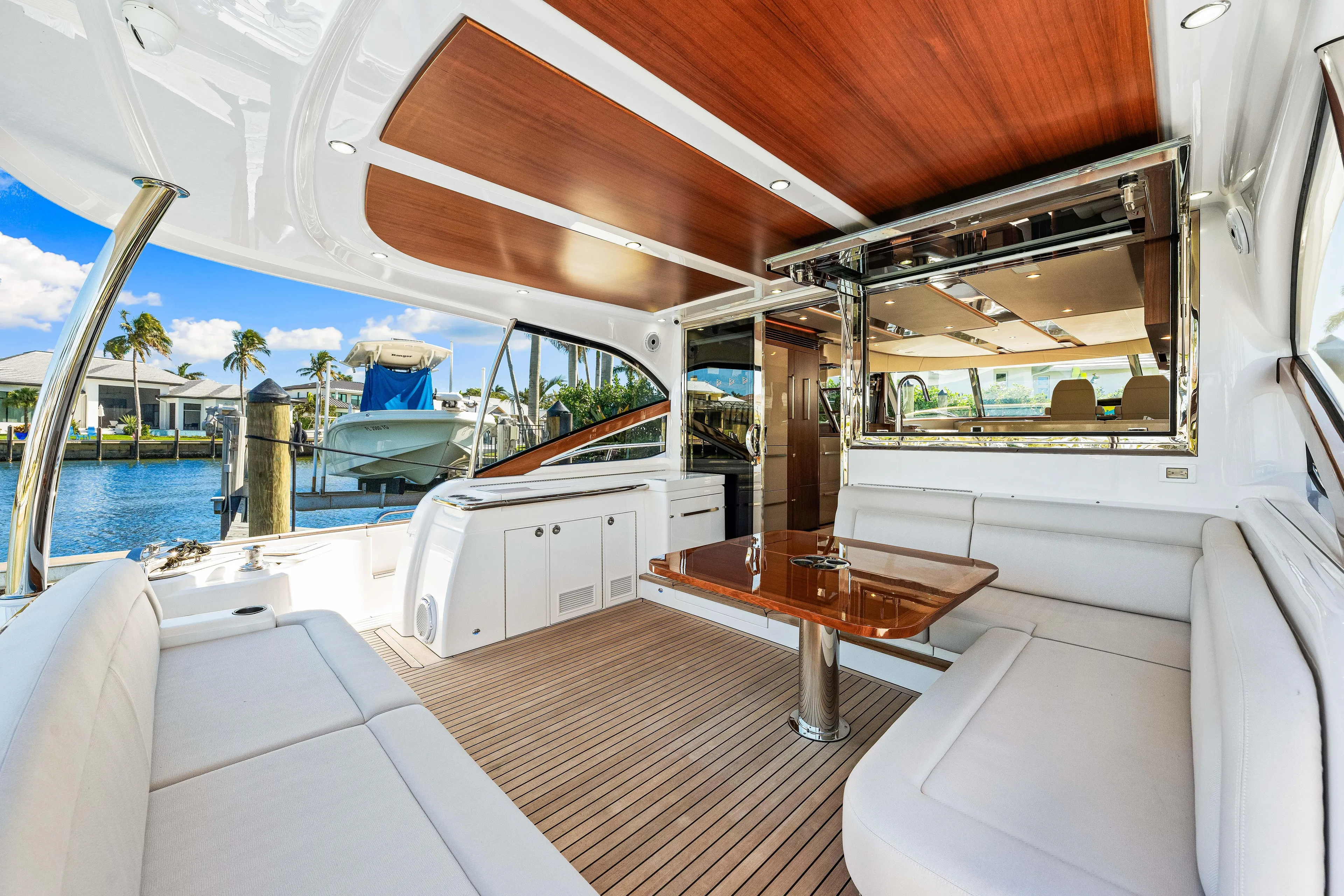 Dog House Yacht Photos Pics Luxurious interior of 2025 Belize 66 Daybridge yacht with elegant seating and wooden accents.