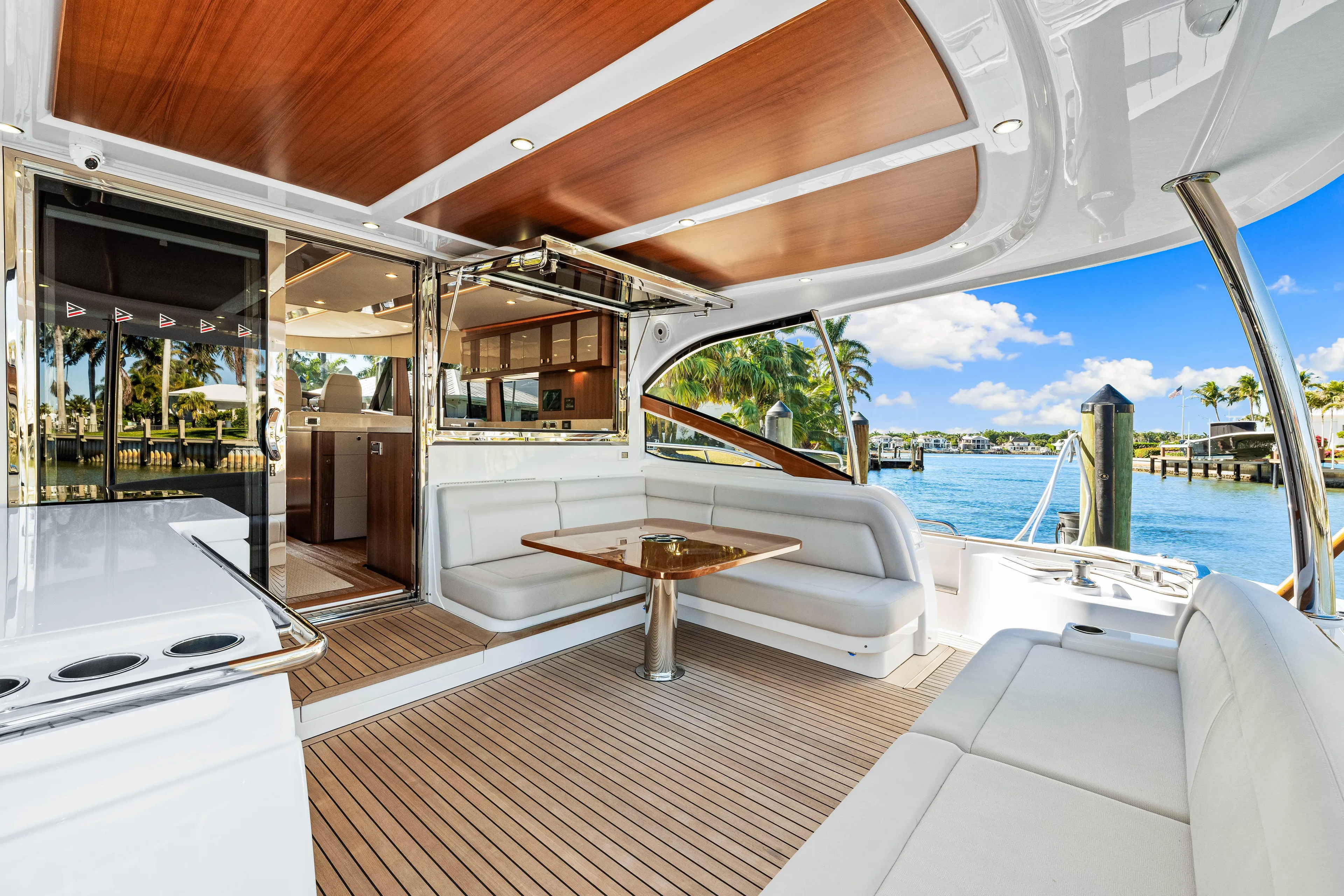 Dog House Yacht Photos Pics Luxurious 2025 Belize 66 Daybridge yacht interior with elegant seating and scenic waterfront view.