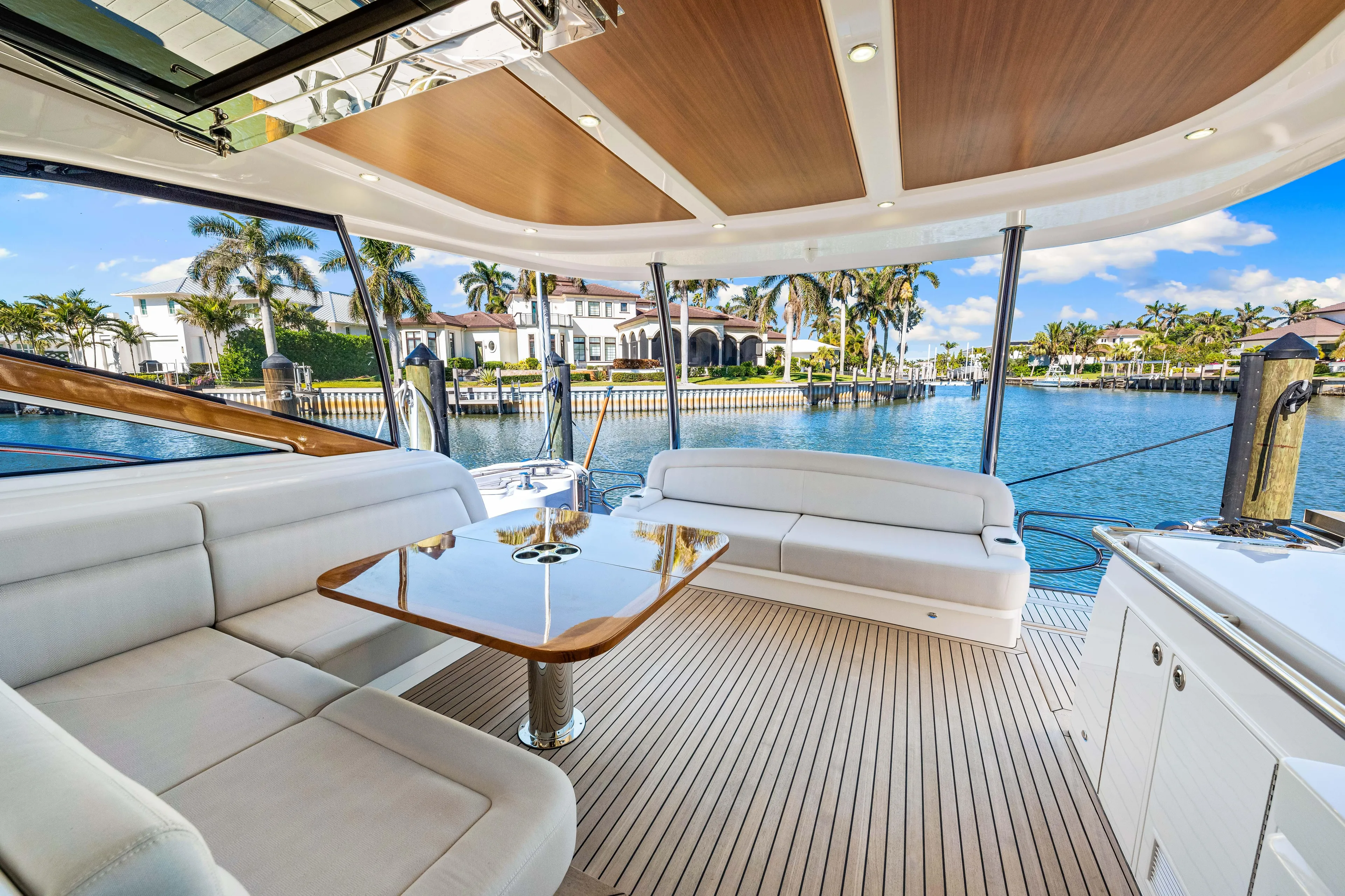 Dog House Yacht Photos Pics Luxurious 2025 Belize 66 Daybridge yacht interior with elegant seating and scenic waterfront view.