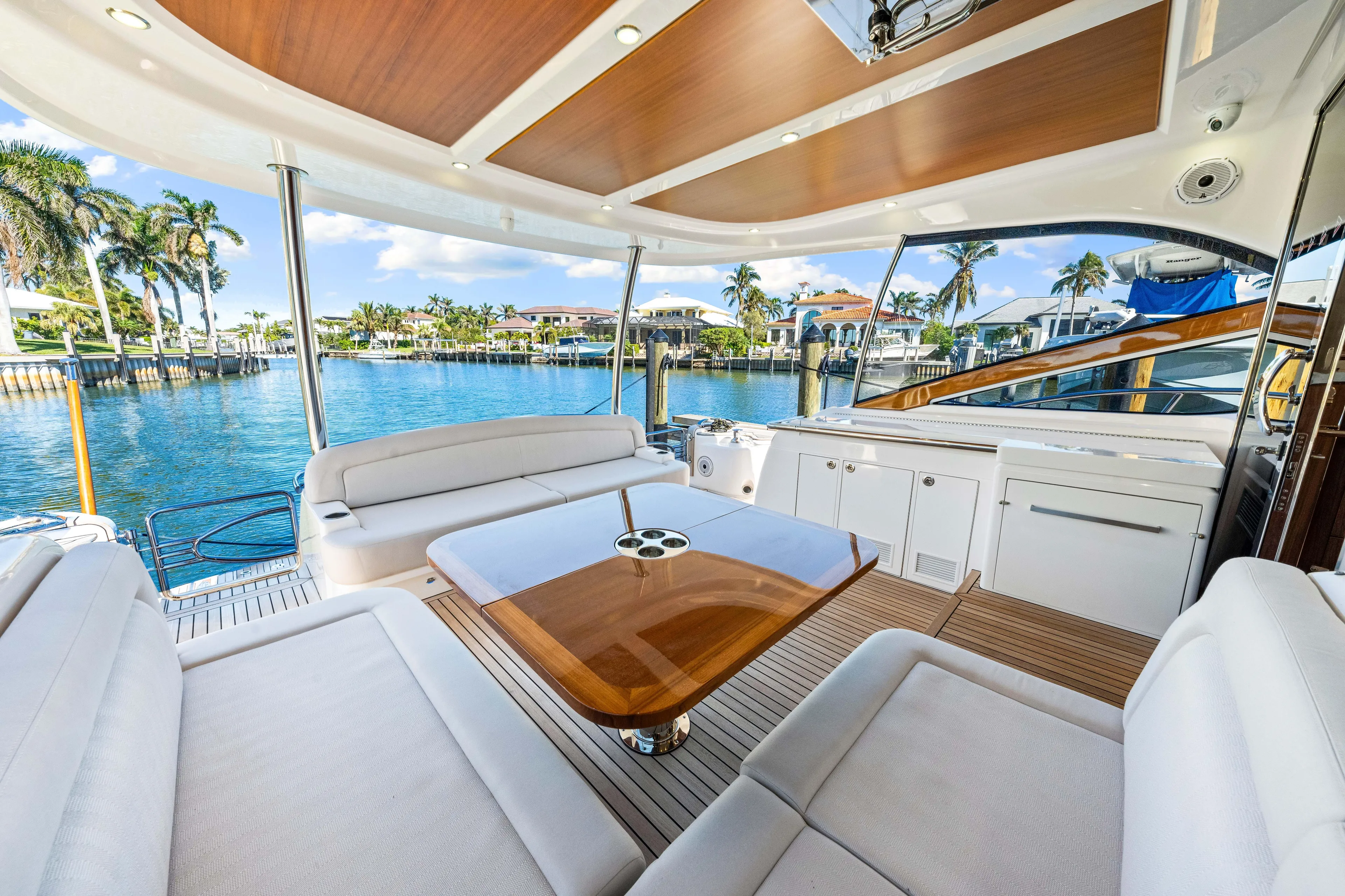 Dog House Yacht Photos Pics Luxurious 2025 Belize 66 Daybridge yacht interior with elegant seating and scenic waterfront view.