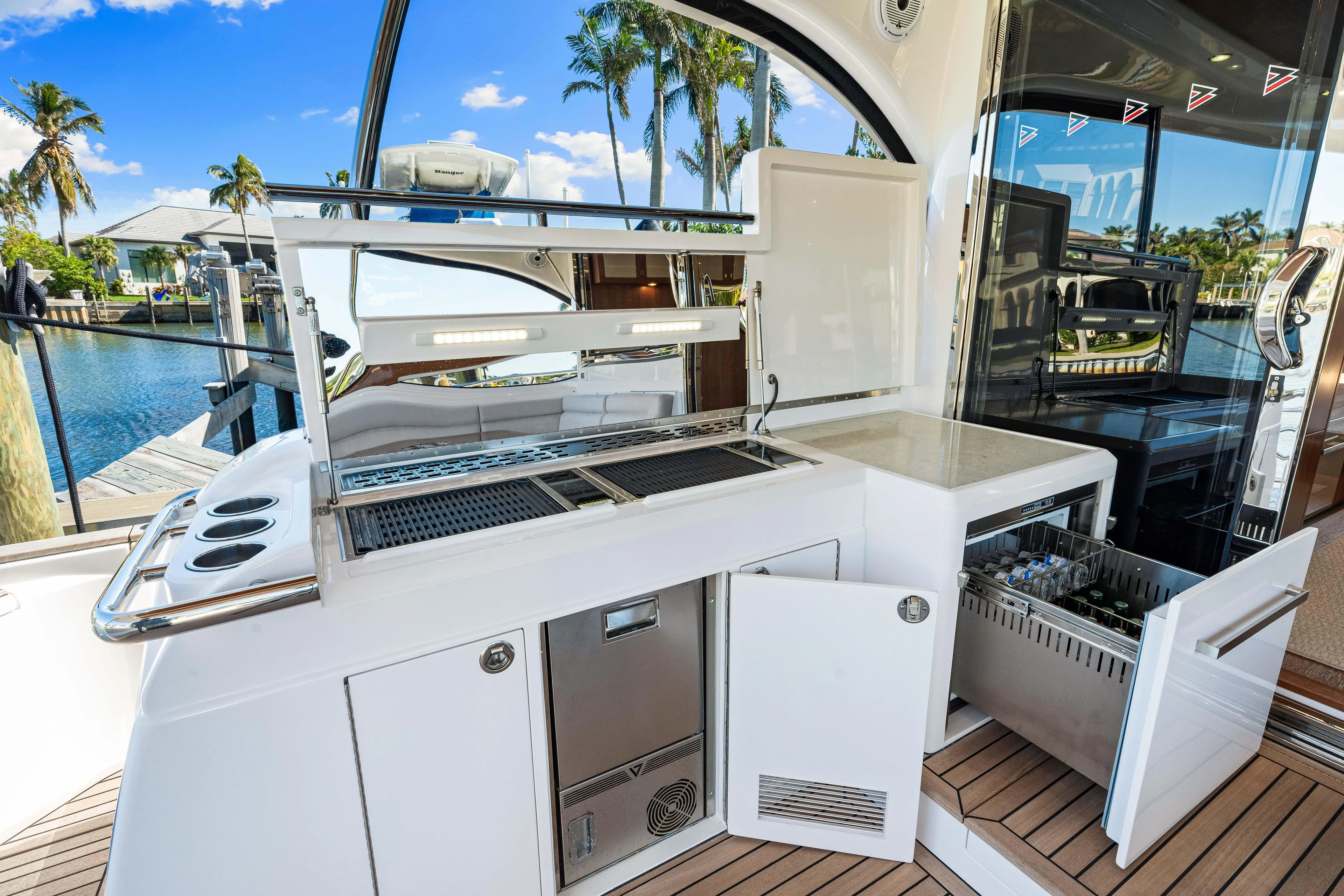 Dog House Yacht Photos Pics Outdoor kitchen on 2025 Belize 66 Daybridge yacht, featuring grill and dishwasher.