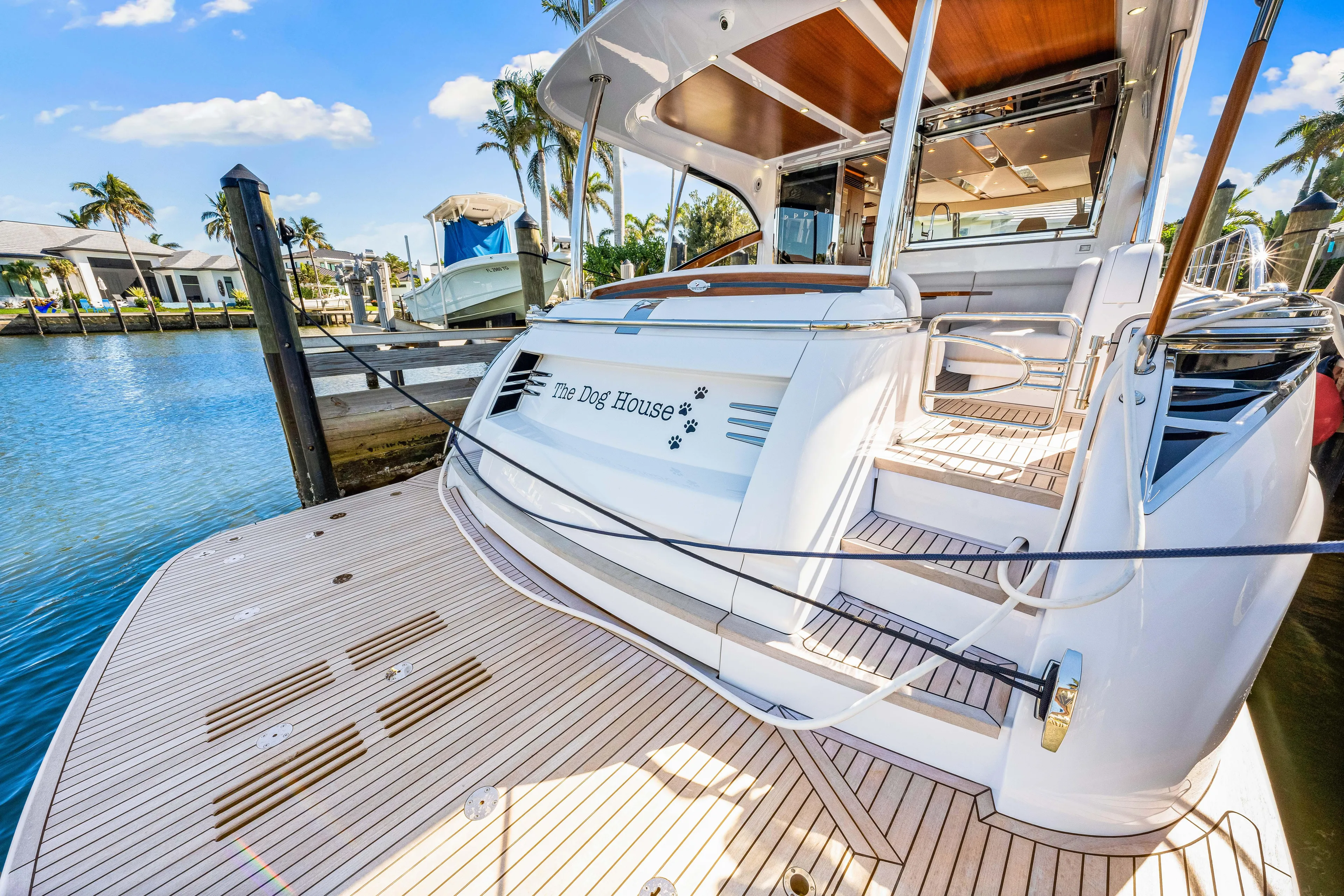 Dog House Yacht Photos Pics 2025 Belize 66 Daybridge yacht docked, showcasing elegant design and spacious deck.