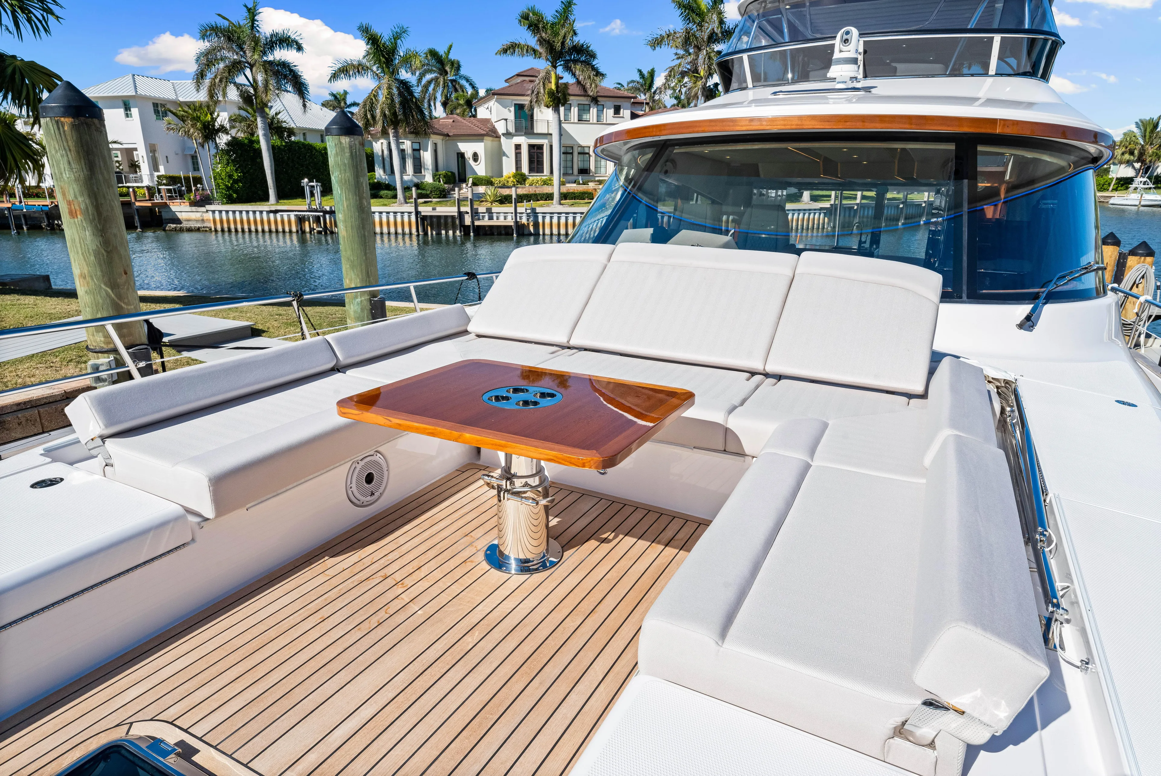 Dog House Yacht Photos Pics 2025 Belize 66 Daybridge yacht with luxurious deck seating and wooden table.