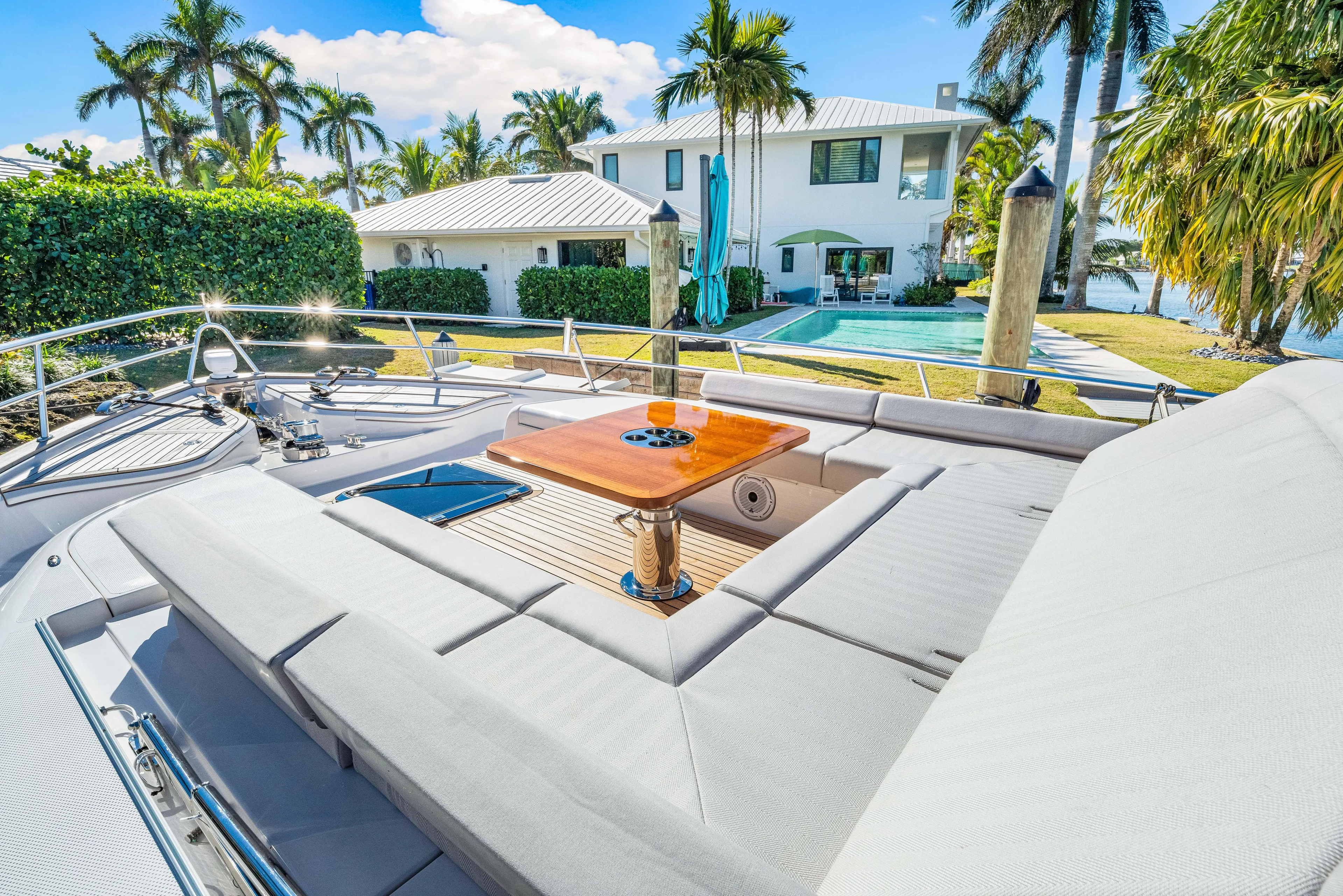 Dog House Yacht Photos Pics Luxurious 2025 Belize 66 Daybridge yacht with sun deck, docked near waterfront property.