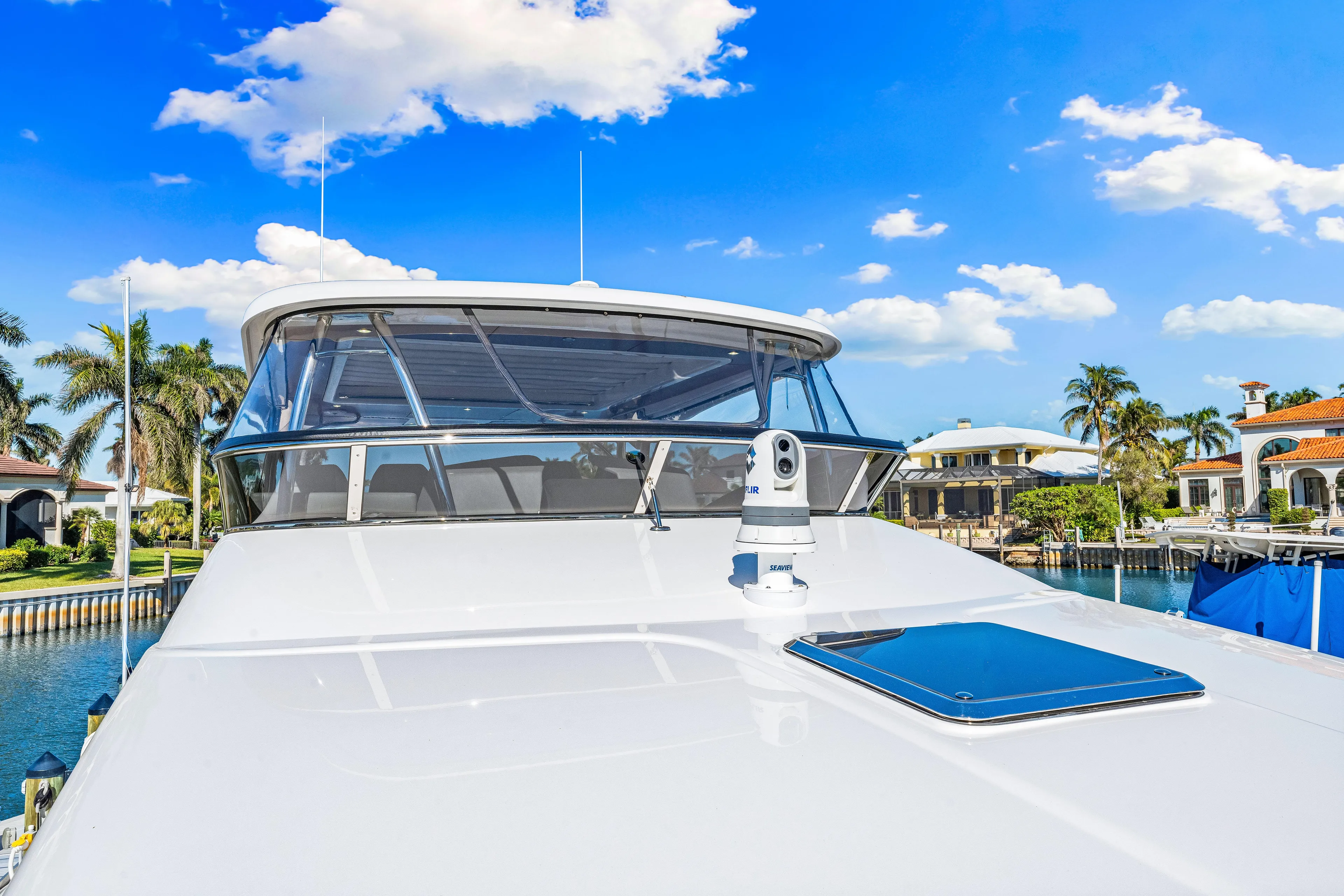 Dog House Yacht Photos Pics 2025 Belize 66 Daybridge yacht, sleek design, docked under clear blue sky.