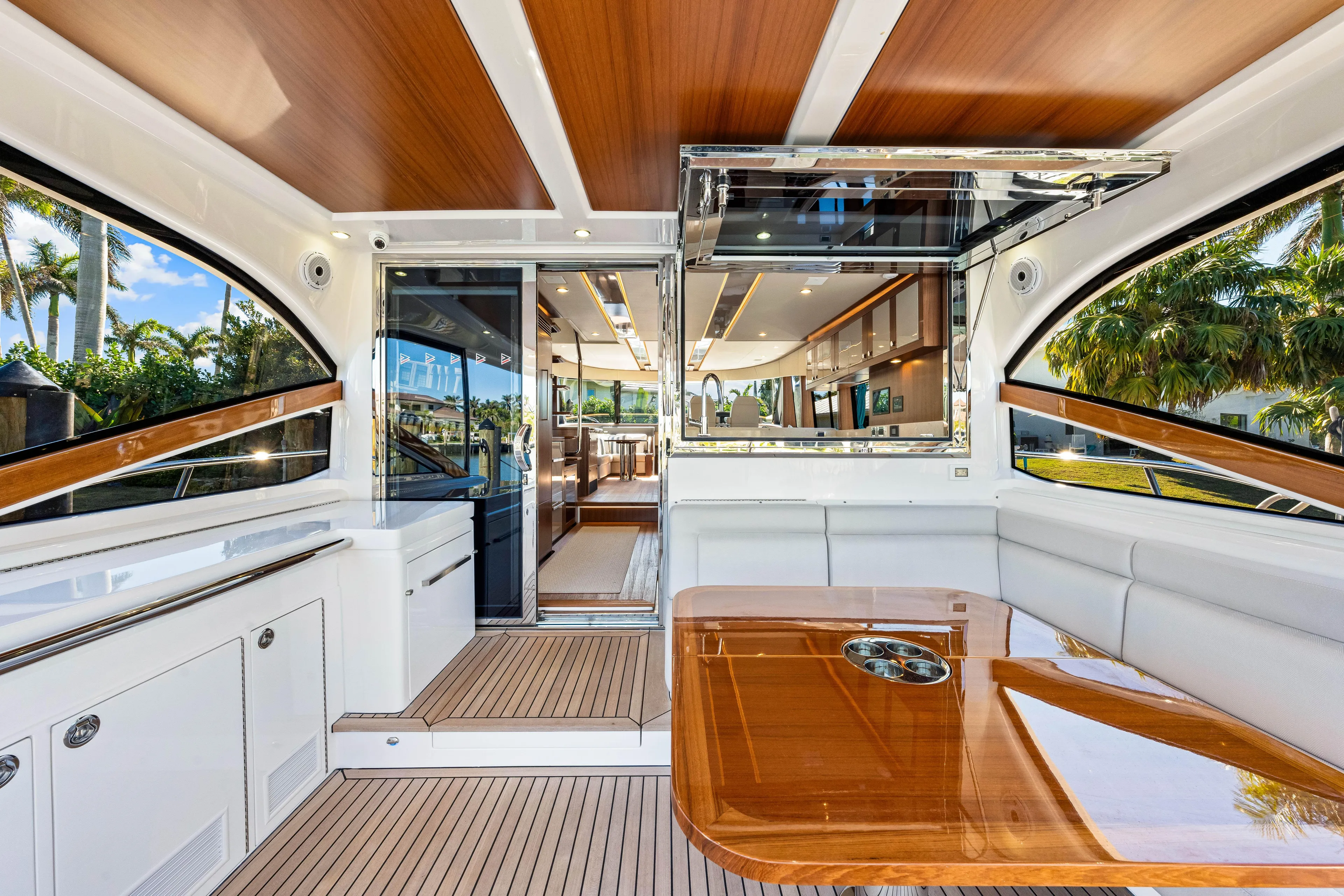 Dog House Yacht Photos Pics Luxurious interior of 2025 Belize 66 Daybridge yacht with elegant wood finishes and spacious seating.