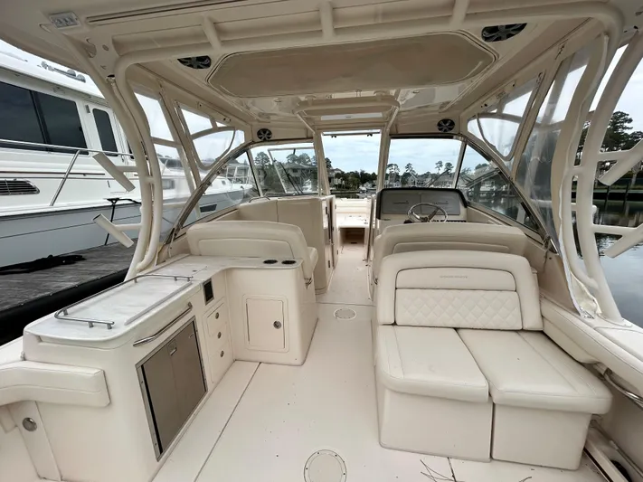 Yacht Photos Pics 2018 Grady-White Freedom 325 boat interior with seating and helm, docked at marina.