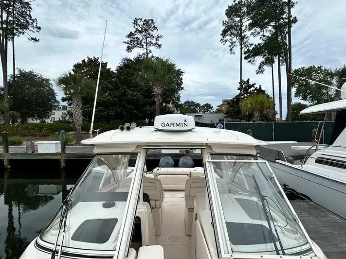  Yacht Photos Pics 2018 Grady-White Freedom 325 boat docked with Garmin equipment, surrounded by trees.