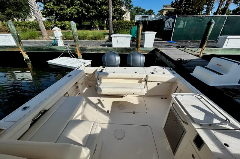  Yacht Photos Pics 2018 Grady-White Freedom 325 boat interior at dock, featuring spacious seating and dual engines.