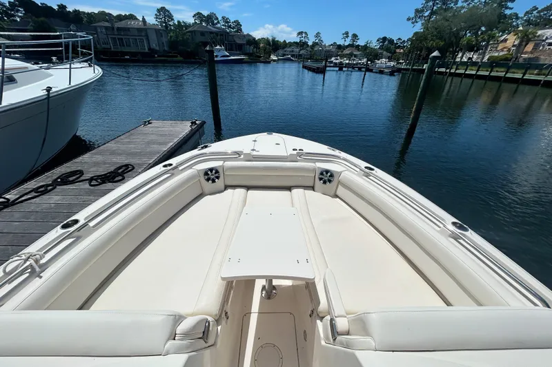  Yacht Photos Pics 2018 Grady-White Freedom 325 boat docked in a serene marina setting.