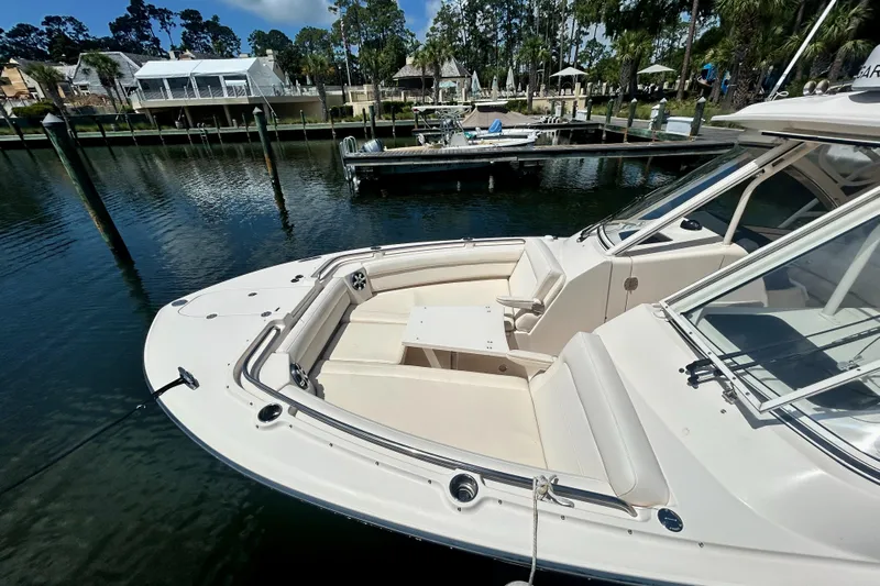  Yacht Photos Pics 2018 Grady-White Freedom 325 boat docked in a serene marina setting.