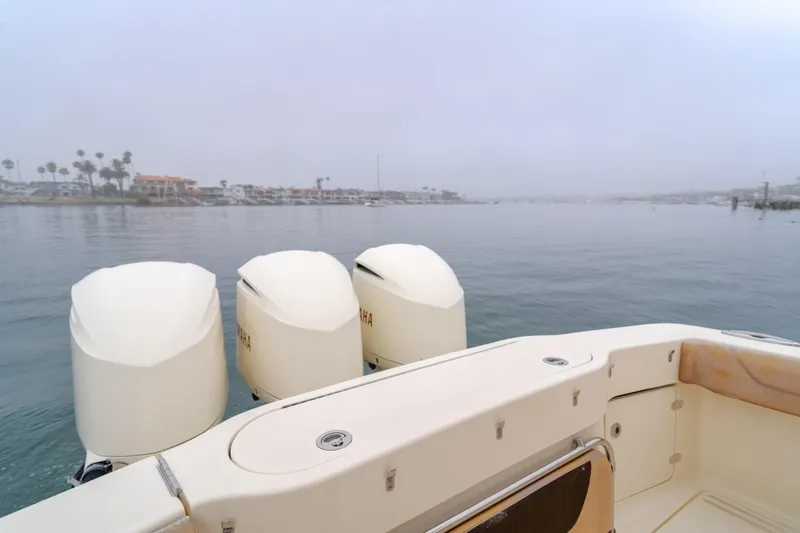 Last Look Yacht Photos Pics 2016 Scout 350 LXF boat with triple engines on calm water.