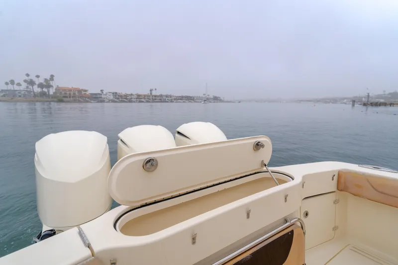 Last Look Yacht Photos Pics 2016 Scout 350 LXF boat on calm water with outboard motors.