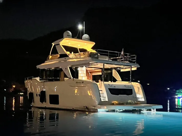  Yacht Photos Pics Luxurious 2017 Absolute NAVETTA 58 yacht illuminated at night on calm waters.