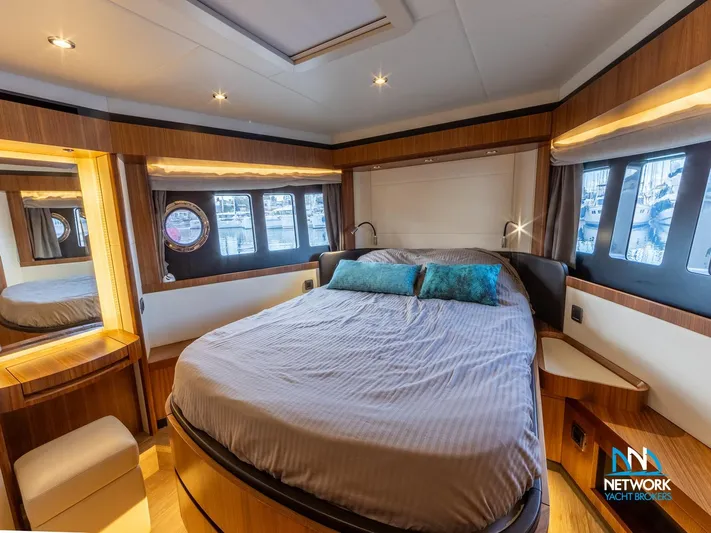  Yacht Photos Pics Luxurious bedroom interior of 2017 Absolute NAVETTA 58 yacht with elegant wood finishes.