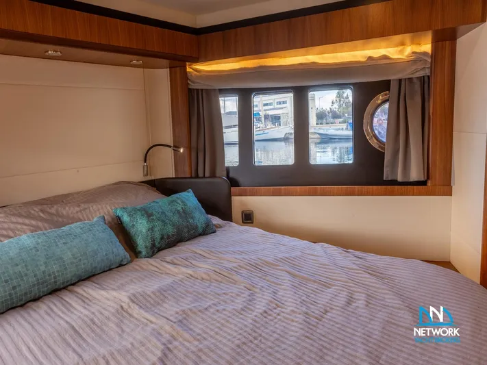 Yacht Photos Pics Luxurious bedroom interior of 2017 Absolute NAVETTA 58 yacht with large windows and elegant decor.