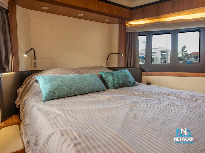  Yacht Photos Pics Luxurious bedroom interior of 2017 Absolute NAVETTA 58 yacht with large bed and windows.