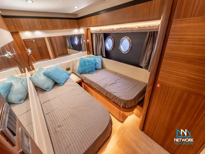  Yacht Photos Pics Luxurious cabin interior of 2017 Absolute NAVETTA 58 yacht with twin beds and portholes.
