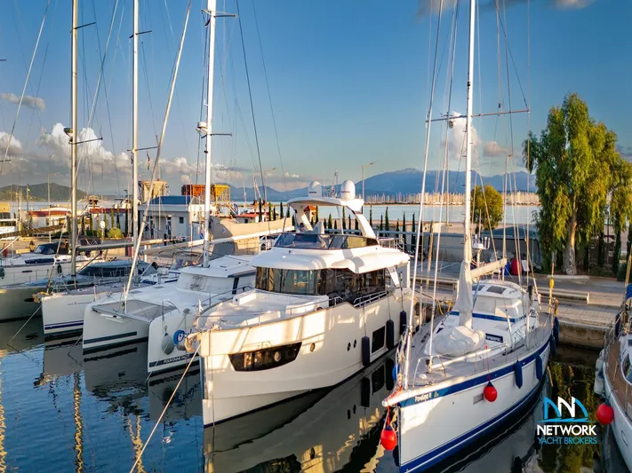  Yacht Photos Pics Luxury yachts docked at marina, featuring 2017 Absolute NAVETTA 58 under clear blue sky.