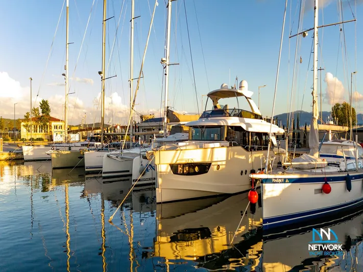  Yacht Photos Pics Luxury yachts docked at marina, featuring 2017 Absolute NAVETTA 58 under a clear blue sky.