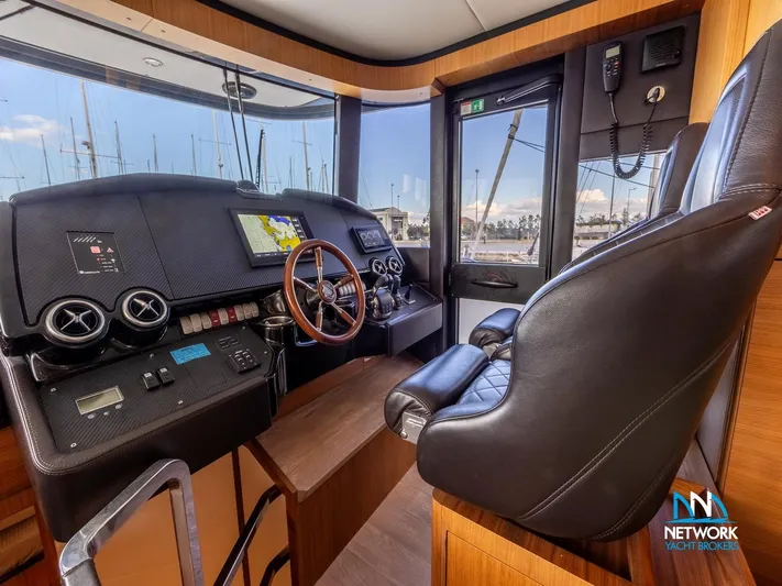  Yacht Photos Pics Interior helm of 2017 Absolute NAVETTA 58 yacht with modern controls and leather seating.