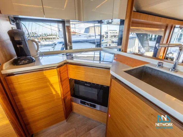  Yacht Photos Pics Modern kitchen interior on 2017 Absolute NAVETTA 58 yacht with wood cabinetry and appliances.
