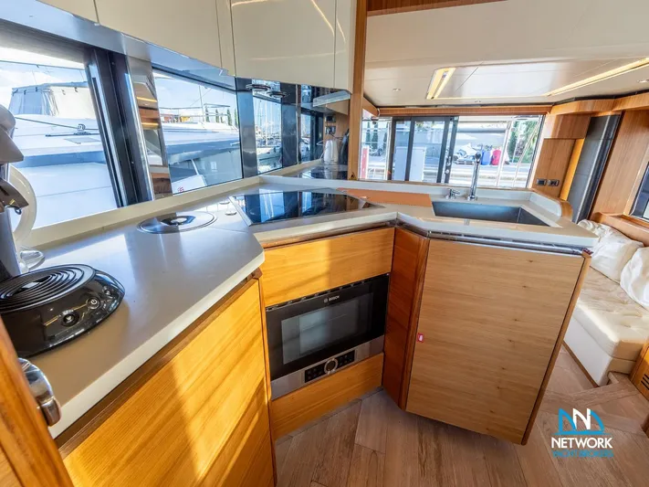  Yacht Photos Pics Modern kitchen interior of 2017 Absolute NAVETTA 58 yacht with wood cabinetry and appliances.