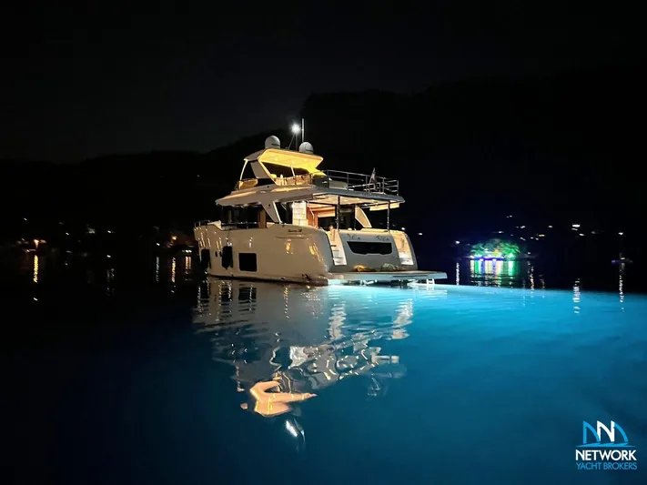  Yacht Photos Pics Luxury yacht Absolute NAVETTA 58, 2017 model, illuminated at night on calm water.