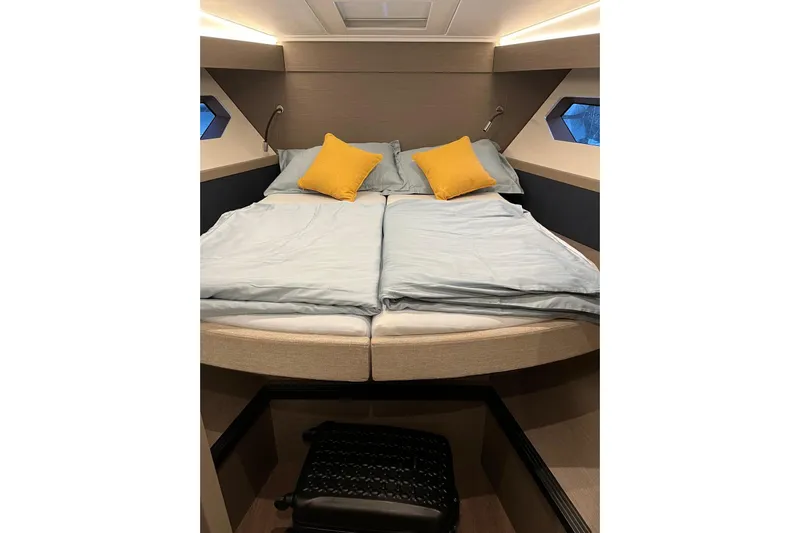  Yacht Photos Pics Luxurious cabin interior of 2024 Beneteau Gran Turismo 45 yacht with cozy bedding.