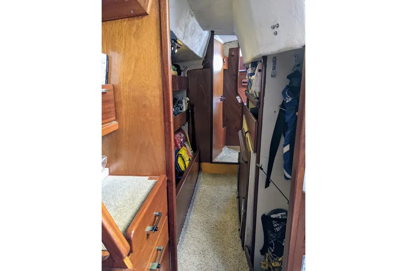 Omorfi Thea Yacht Photos Pics Interior view of 1993 Amel Santorin sailboat with wooden cabinetry and storage.