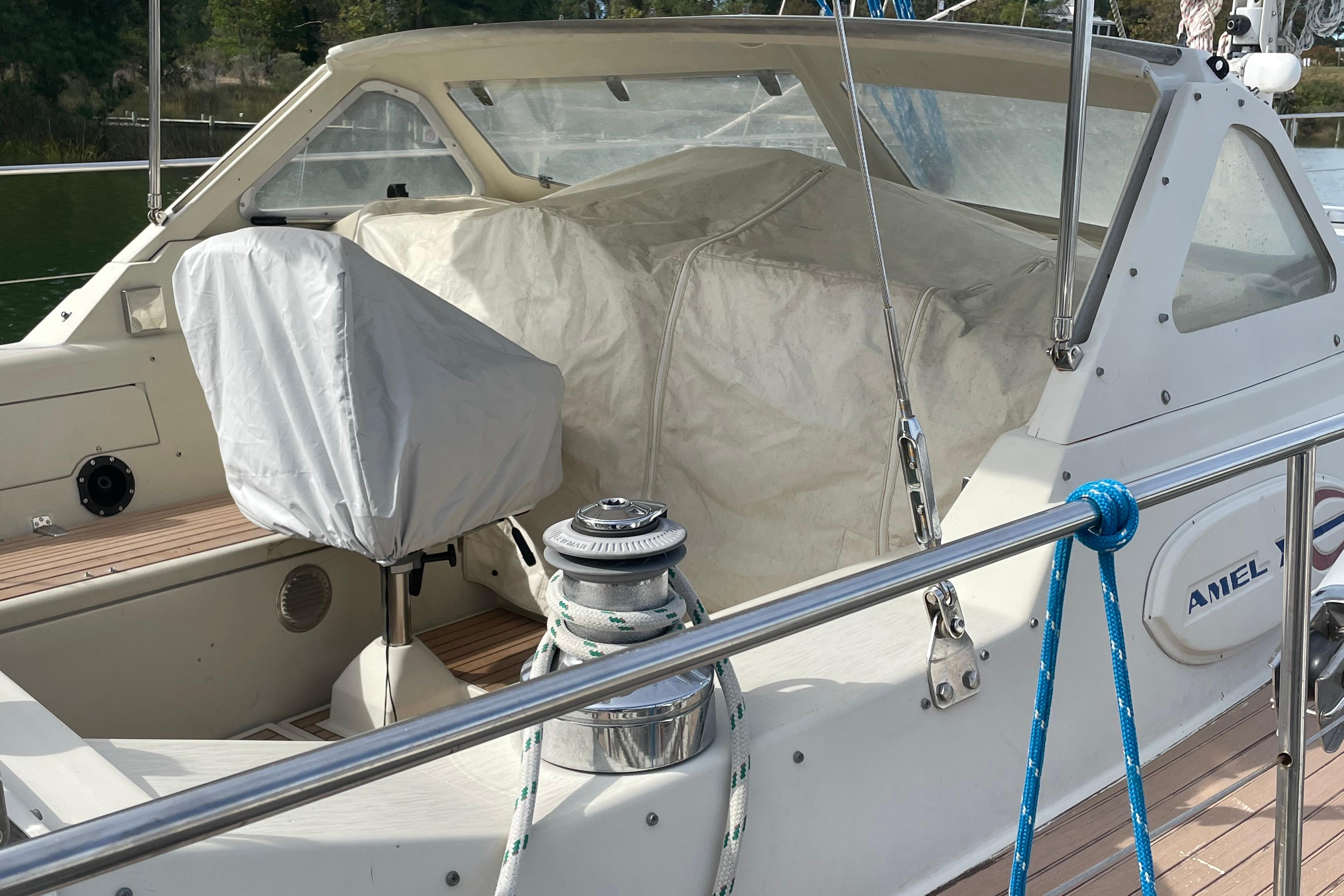 1993 Amel Santorin sailboat cockpit with covered seating and winch.