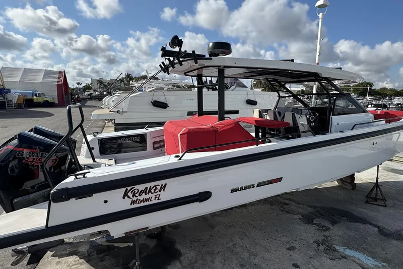 Kraken Yacht Photos Pics 2023 BRABUS Shadow 900 ST boat docked, featuring sleek design and red seating.